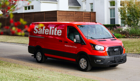 Safelite mobile glass shop being driven by a technician down a street