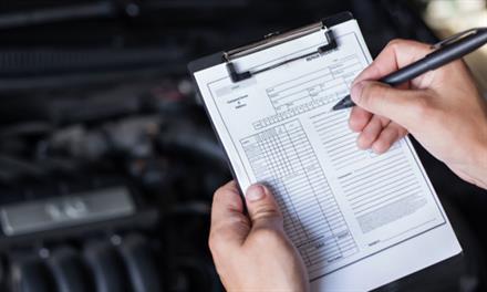mechanic with vehicle maintenance list