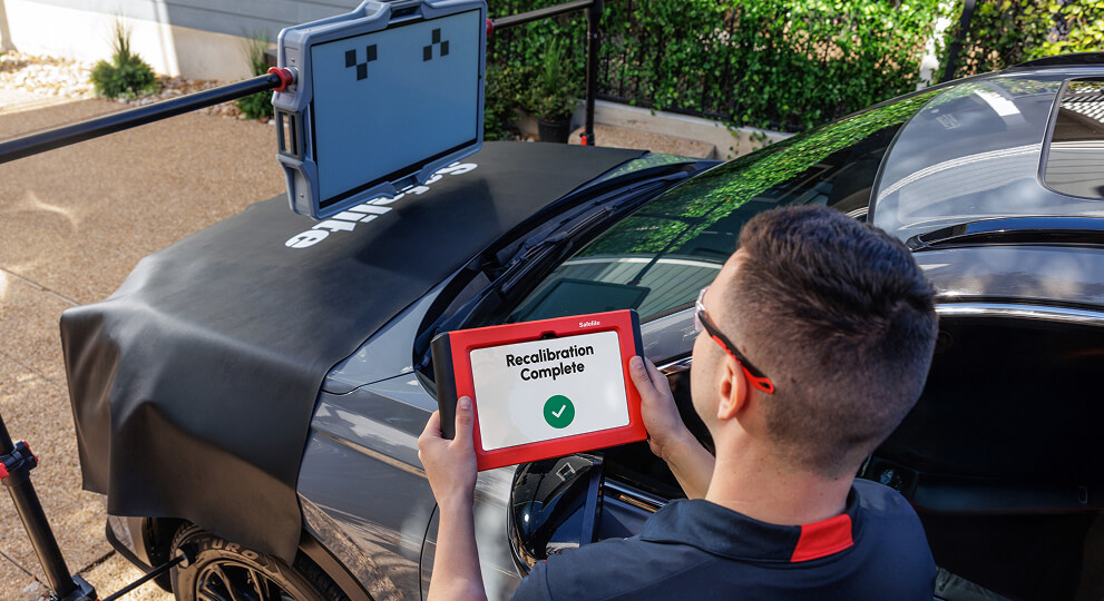 A Safelite technician recalibrating a vehicle’s ADAS system