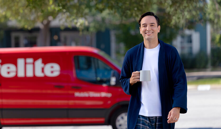 Photo of a customer at home while Safelite technician is performing service.