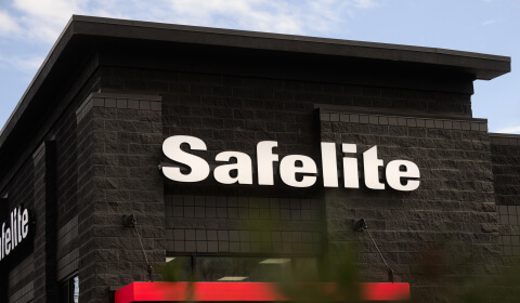 Safelite logo above the entrance to a Safelite shop