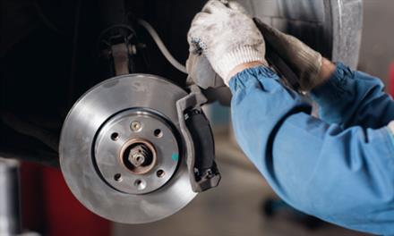 mechanic inspecting brakes